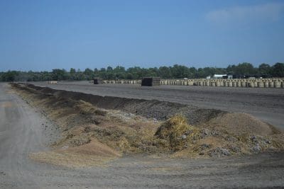 Compost materials are mixed in long windrows which are kept moist and turned regularly.