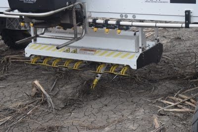 The mechanical weeding system features a gang of hoe-like implements that extend individually to rake out weeds as the machine passes over them.