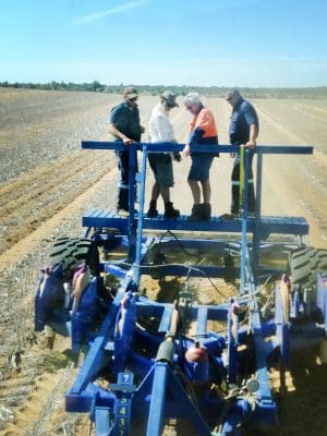 Kyle Carson, (of Binnu), Paul Blackwell (DAFWA), Rohan Ford (Balla) and Murray Carson (Binnu) look over the trial ripper to investigate topsoil slotting at the trial site in Binnu in 2016.