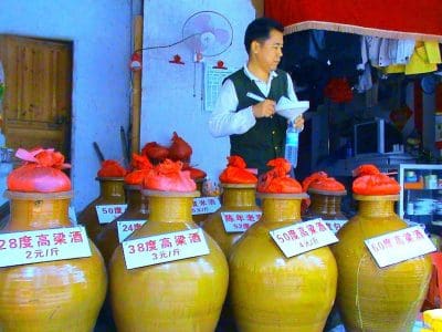 Crockery jars of locally-made baijiu in a liquor store in Haikou, Hainan, China, with signs indicating alcoholic content and price per jin (500 grams). Source: Wikipedia